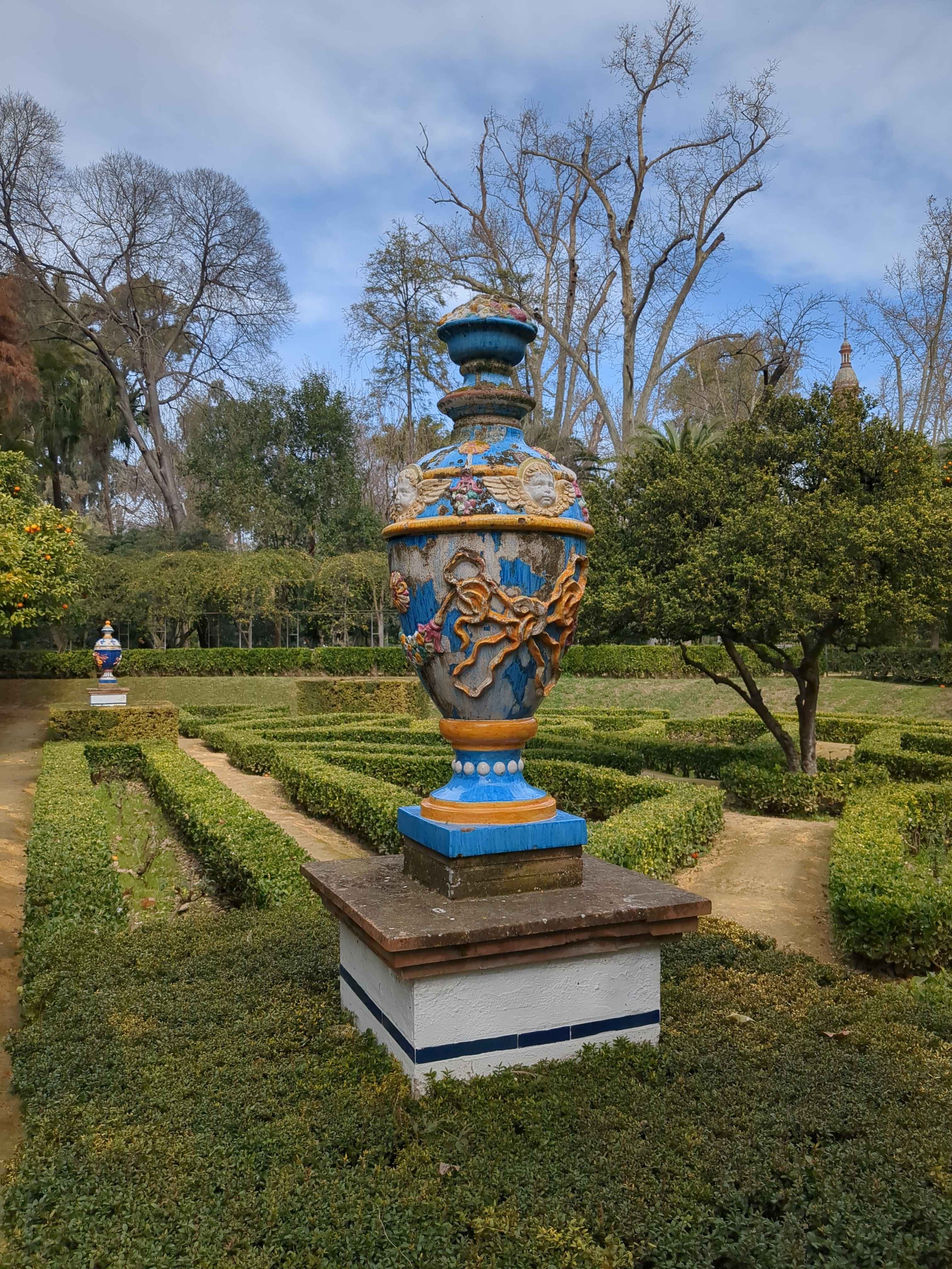 an ornate blue vase in a garden