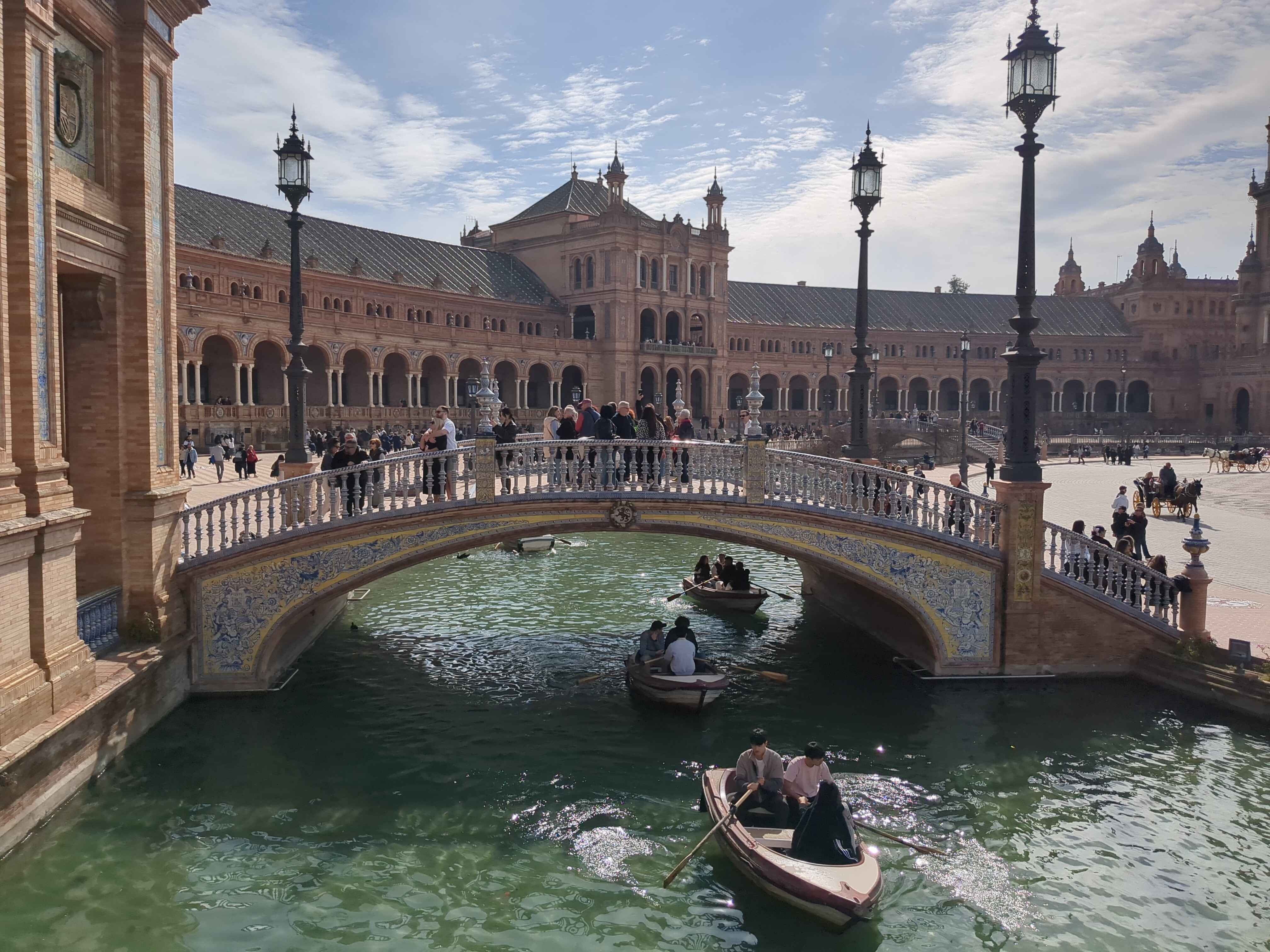 a bridge and water with boats passing underneath