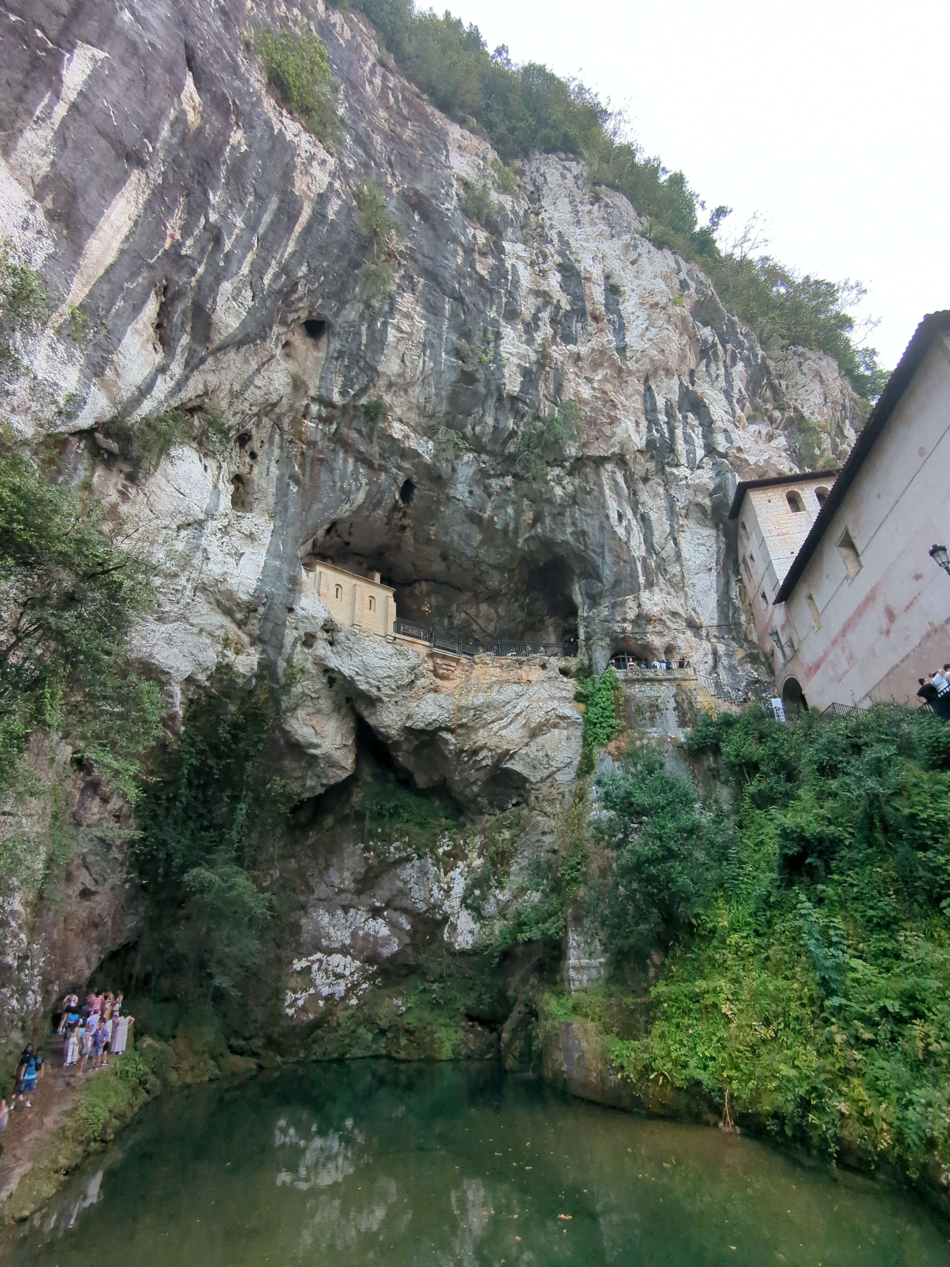 "a monastery above a pool of water"