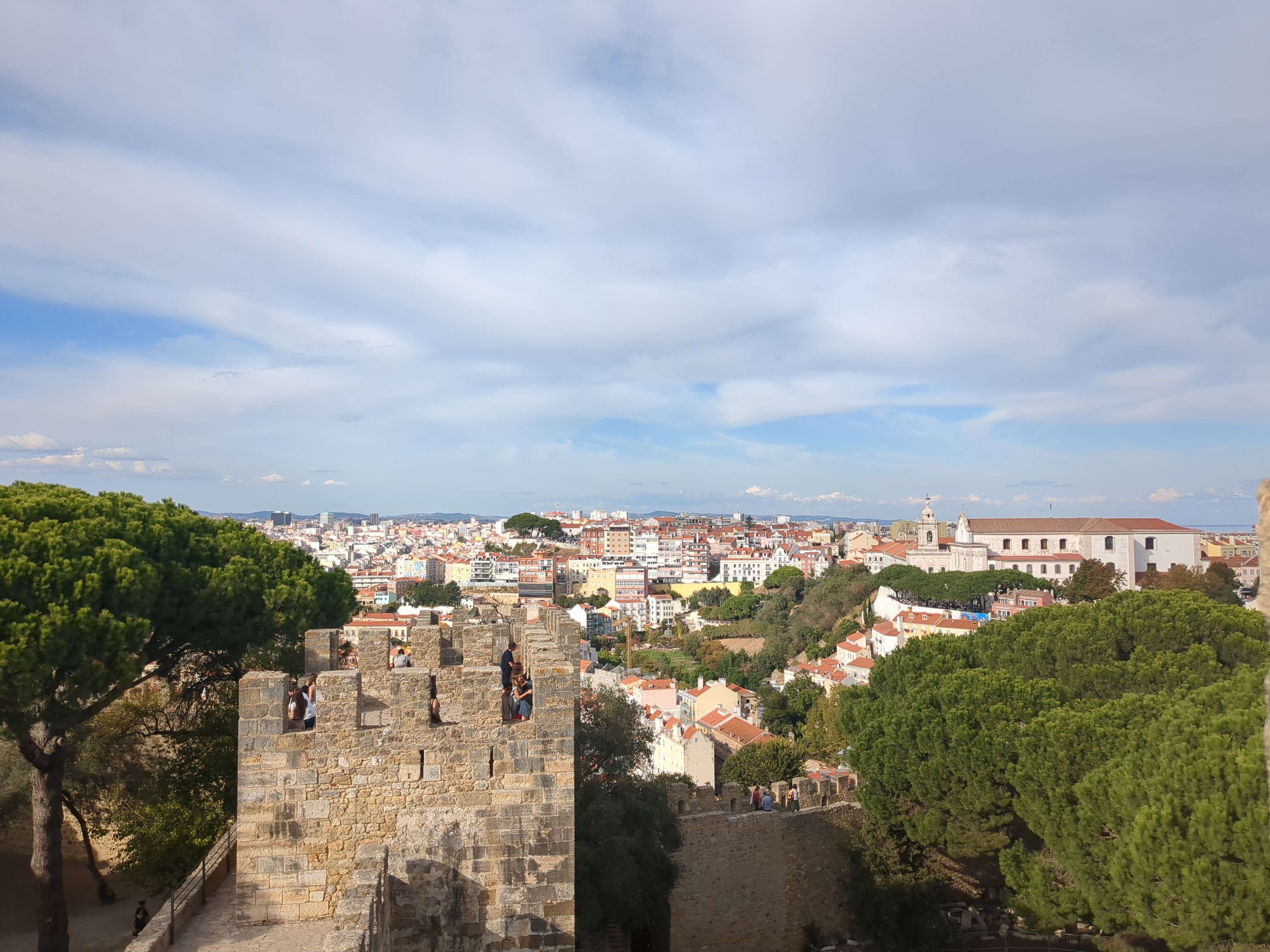 "a view of lisbon with a castle in the foreground"