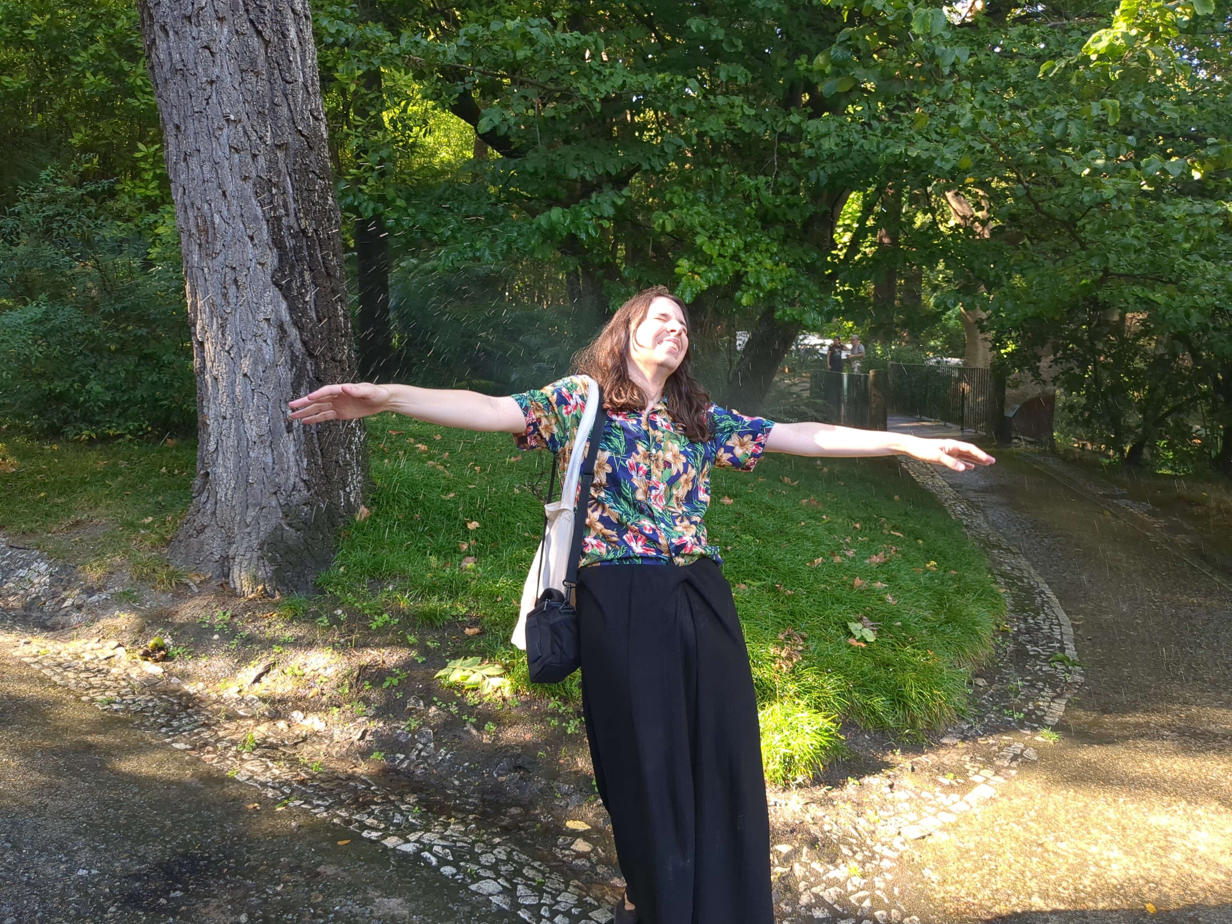 "foto being hit by a sprinkler"