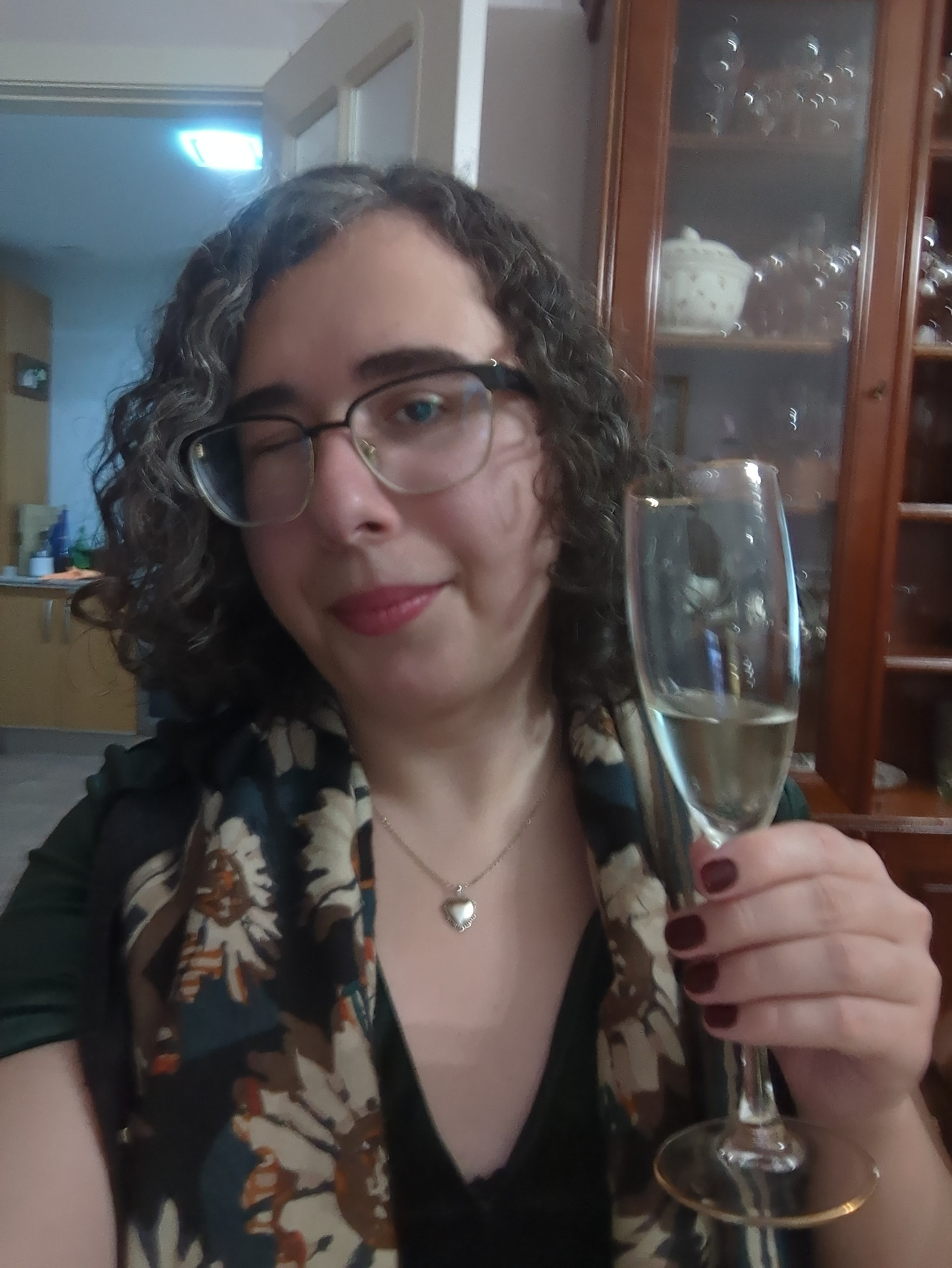 "bagenzo in a green dress holding champagne"